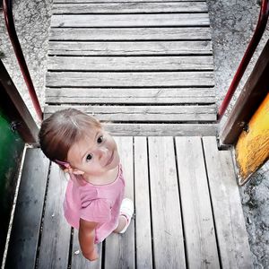 Portrait of cute girl standing on boardwalk