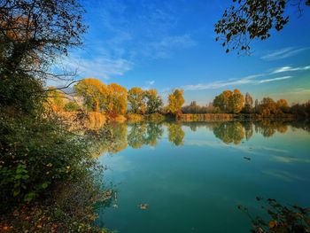 Scenic view of lake against sky during autumn