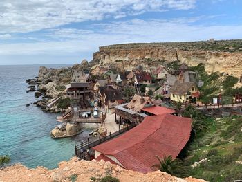 Panoramic view of townscape by sea against sky