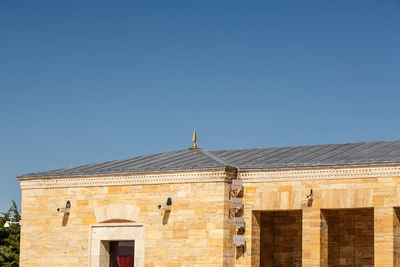 Low angle view of building against clear blue sky