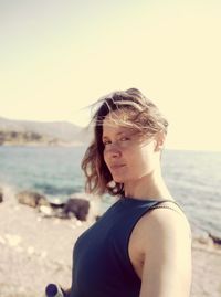 Portrait of woman looking at sea against sky