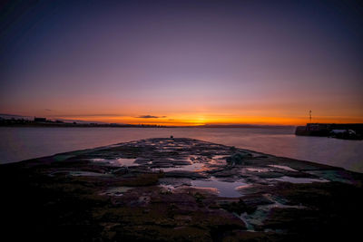 Scenic view of sea against romantic sky at sunset