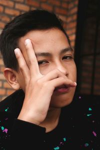 Portrait of young man against wall