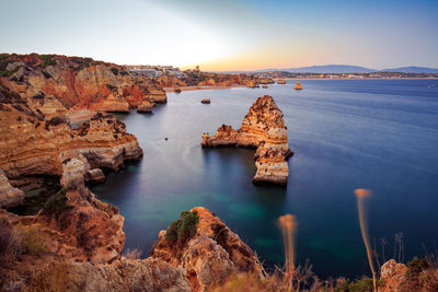 Scenic view of sea and rock formations against sky