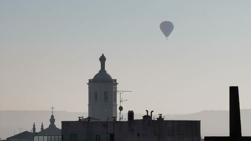 Silhouette buildings against sky during sunset