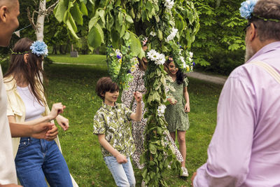 People dancing around midsummer maypole