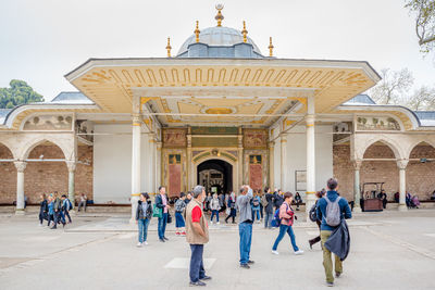 Group of people in front of historic building