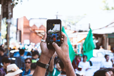 Low section of person photographing with mobile phone