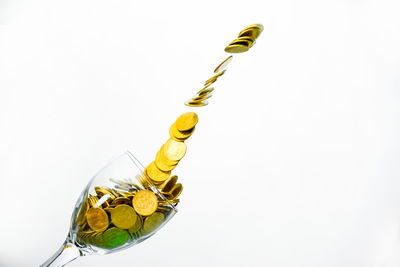 High angle view of yellow bell hanging on white background