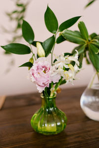 Pink eustoma and white hyacinth flowers in a glass vase in the decor of the house or table