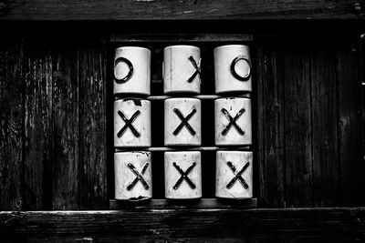 Stack of cups with alphabets on wooden rack