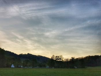 Scenic view of field against sky during sunset