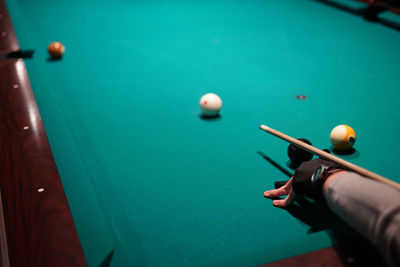 Cropped hand playing pool