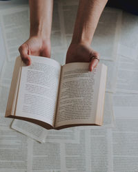 Midsection of woman reading book