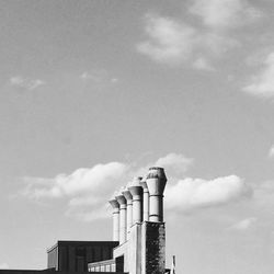 Low angle view of building against cloudy sky