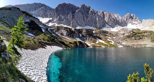 Scenic view of sea and mountains against sky