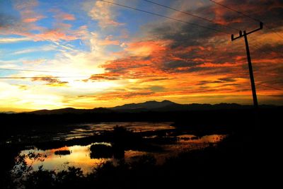 Scenic view of lake against orange sky