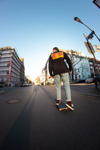 Rear view of man on road against sky