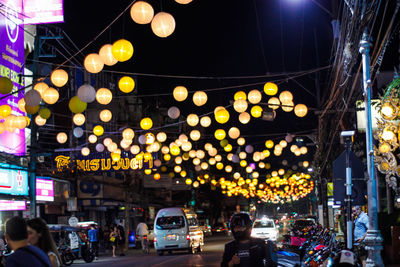 People on illuminated city street at night