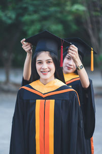 Portrait of smiling young woman standing outdoors