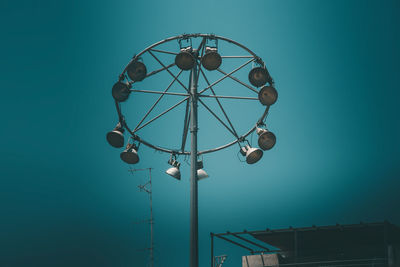 Low angle view of street light against blue sky