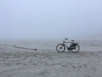 Bicycle on beach in fog 