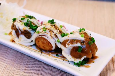 High angle view of fresh takoyaki served on table at restaurant