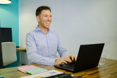 Businesswoman using laptop at office