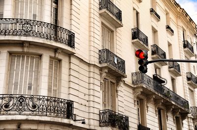 Low angle view of road signal against buildings