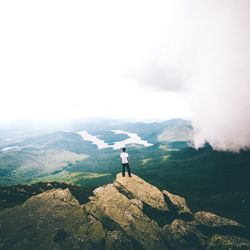 Man standing on mountain against sky