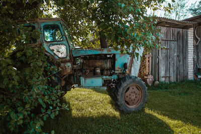 Abandoned vintage car on field