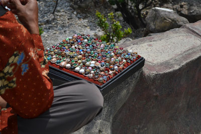 Midsection of man selling rings