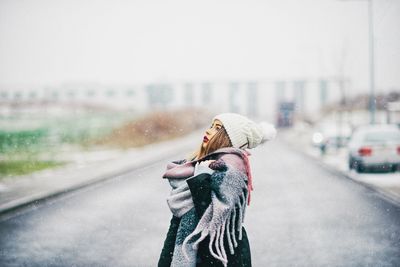 Woman on road in city during winter