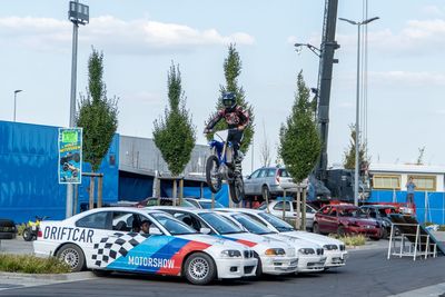 Cars on street against sky