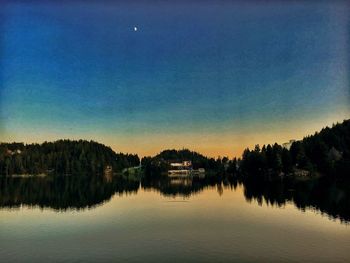 Scenic view of lake against sky at night