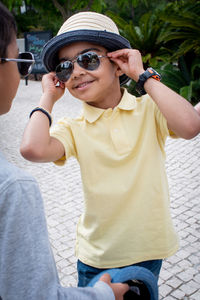 Boy wearing sunglasses and hat