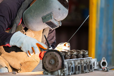 Midsection of man working at workshop