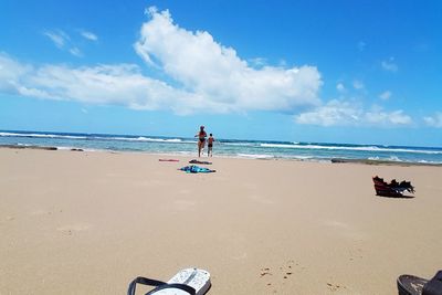 People on beach against sky