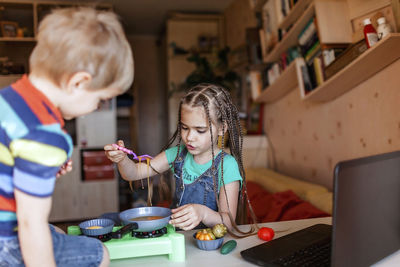 Cheerful kids with food on table