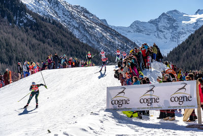 People skiing on snowcapped mountains during winter