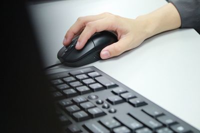 Cropped image of businesswoman working on computer in office