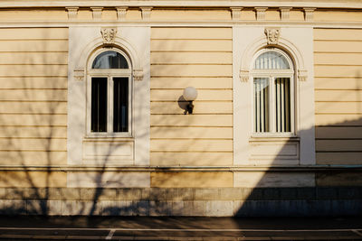 A wall of a beautiful building illuminated by sun