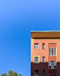 Low angle view of building against blue sky