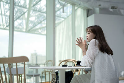 A woman in a cafe on a bright afternoon