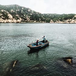 People in boat on sea