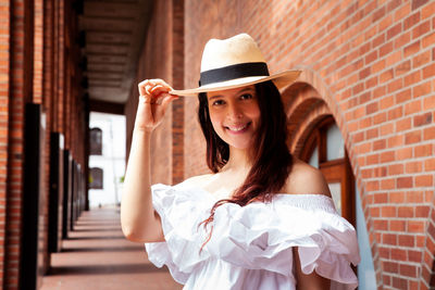 Beautiful young woman wearing a traditional hat from aguadas in colombia called an aguadeño hat.