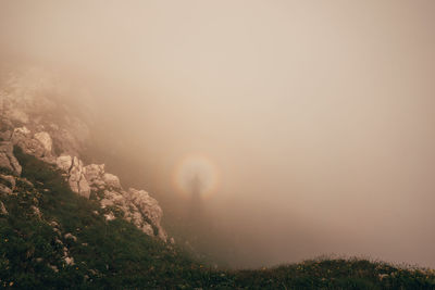 Scenic view of landscape against sky during foggy weather