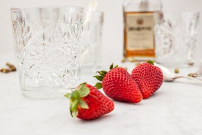 Close-up of strawberries in glass jar on table