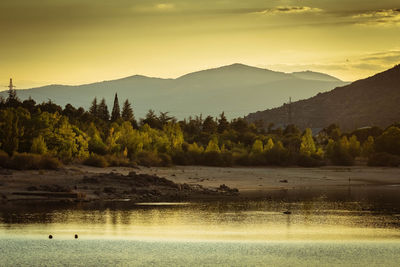 Scenic view of lake against sky during sunset