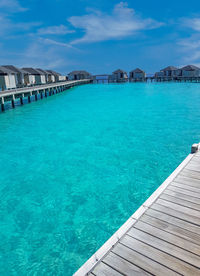 Scenic view of swimming pool by sea against sky